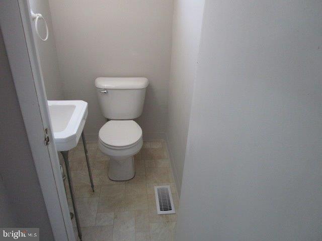 116 Sylvan Terrace Glassboro, NJ 08028 - Photo 6 of 7 a white toilet sitting in a bathroom next to a sink