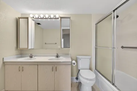a bathroom with a toilet a sink and a mirror