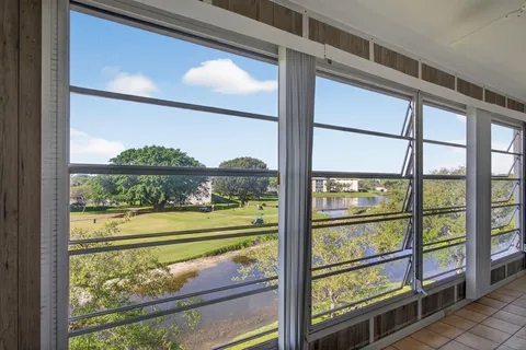 a view of a room with wooden floor and outdoor view