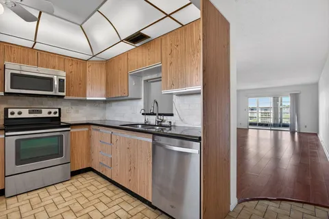a kitchen with stainless steel appliances granite countertop a stove and a microwave