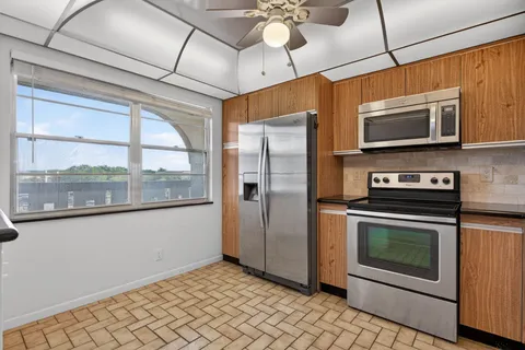 a kitchen with stainless steel appliances granite countertop a stove cabinets and a sink
