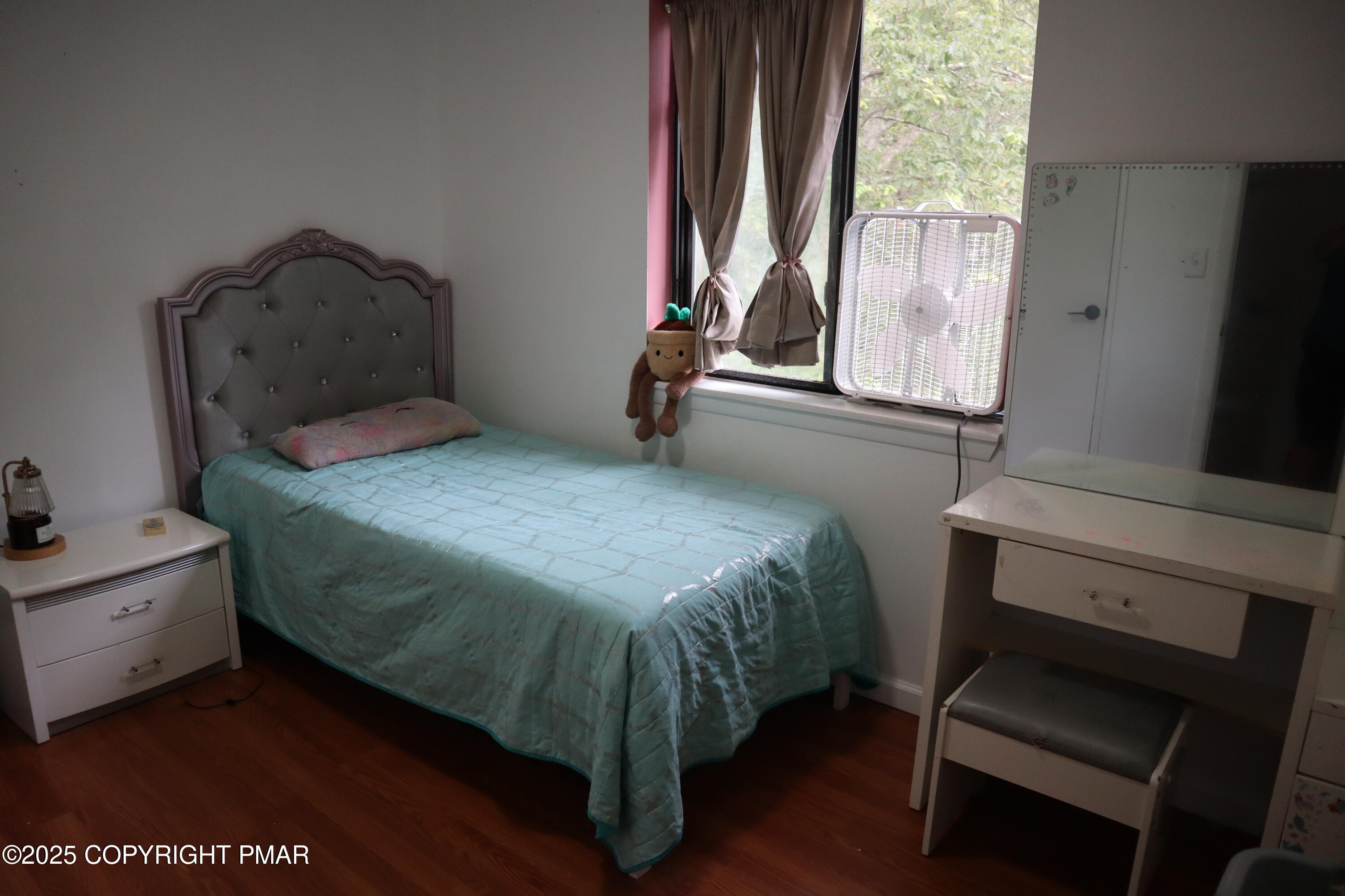 2116 Bobolink Trail Bushkill, PA 18324 - Photo 13 of 19 a bedroom with a bed and a flat tv screen on the dresser
