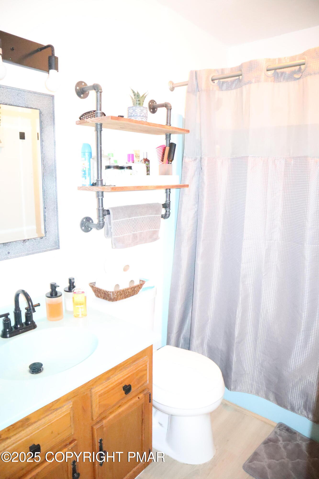 2116 Bobolink Trail Bushkill, PA 18324 - Photo 15 of 19 a bathroom with a sink a toilet and shower curtain
