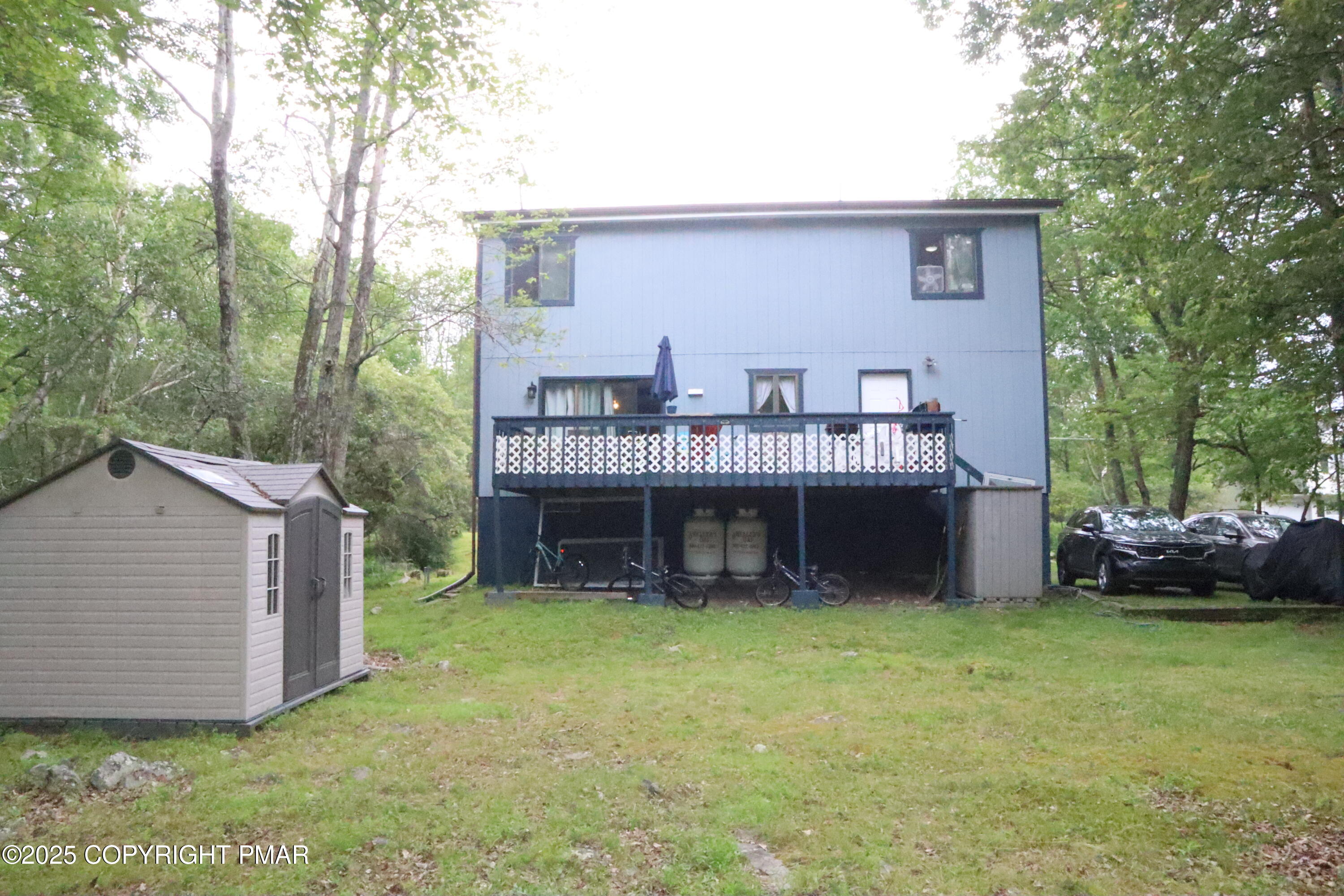 2116 Bobolink Trail Bushkill, PA 18324 - Photo 18 of 19 a view of a house with a yard and deck