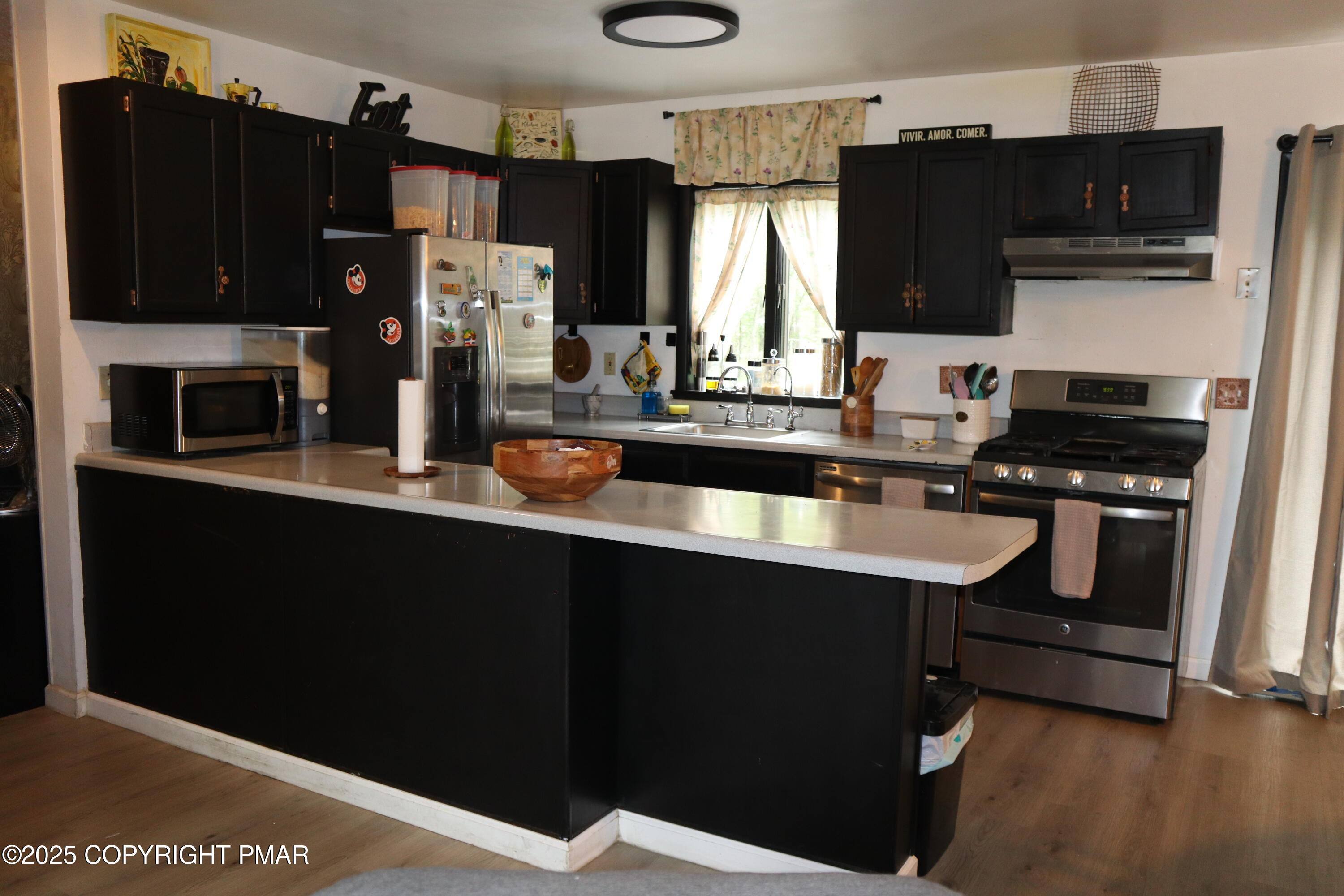 2116 Bobolink Trail Bushkill, PA 18324 - Photo 5 of 19 a kitchen with refrigerator and cabinets