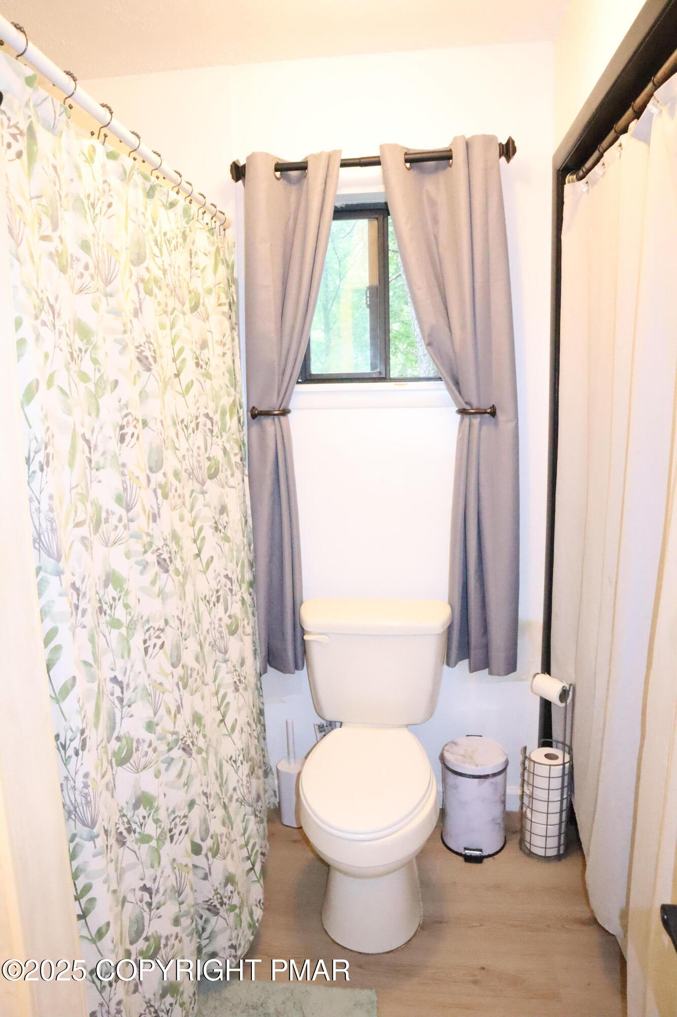 2116 Bobolink Trail Bushkill, PA 18324 - Photo 7 of 19 a white toilet sitting next to a shower curtain
