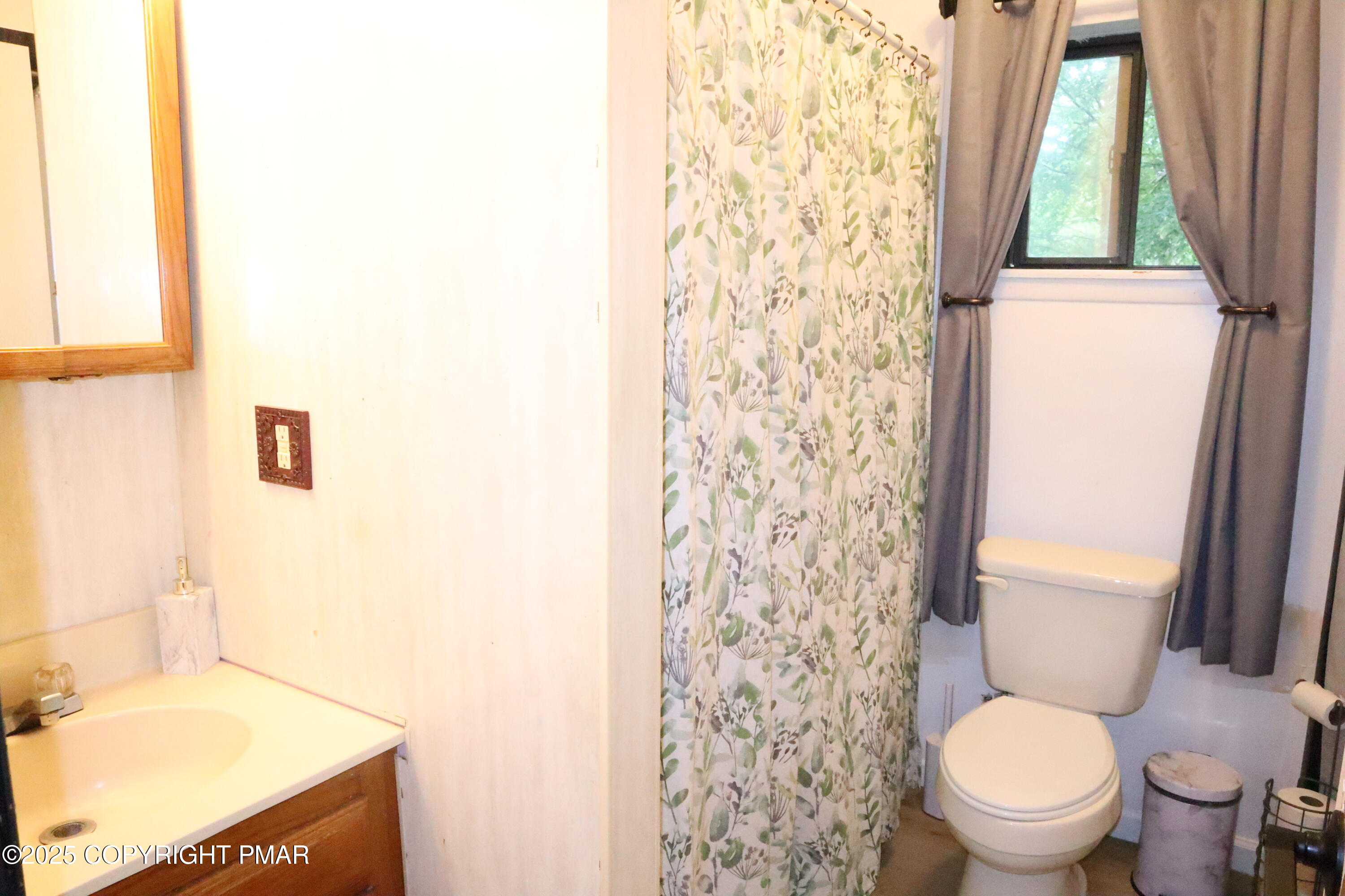 2116 Bobolink Trail Bushkill, PA 18324 - Photo 8 of 19 a white toilet sitting next to a shower curtain