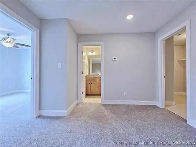 an empty room with a bathroom and a sink