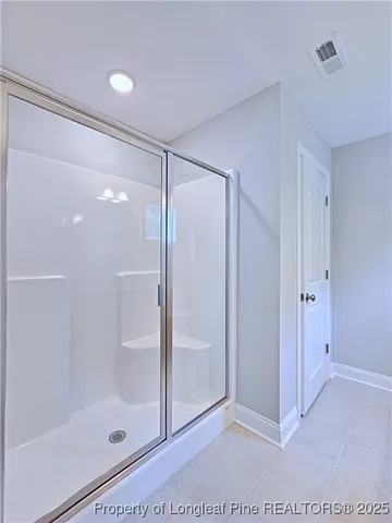 a bathroom with a glass shower door