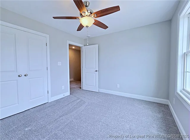an empty room with chandelier fan