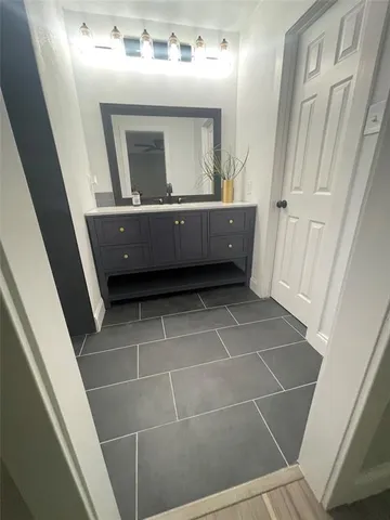 a bathroom with a sink mirror and toilet