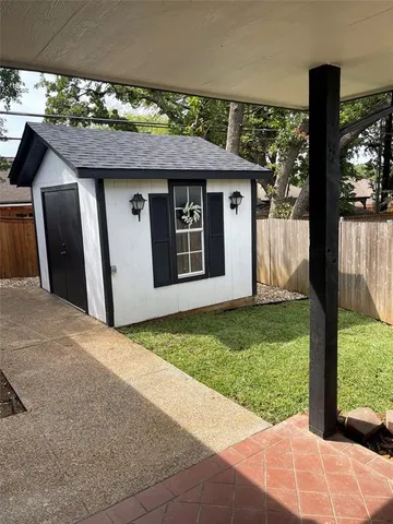 a view of a house with a porch and floor to ceiling window