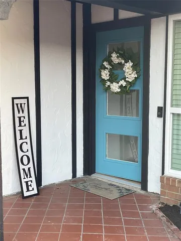 a view of a door and a potted plant