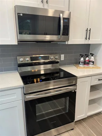 a kitchen with a stove and a microwave