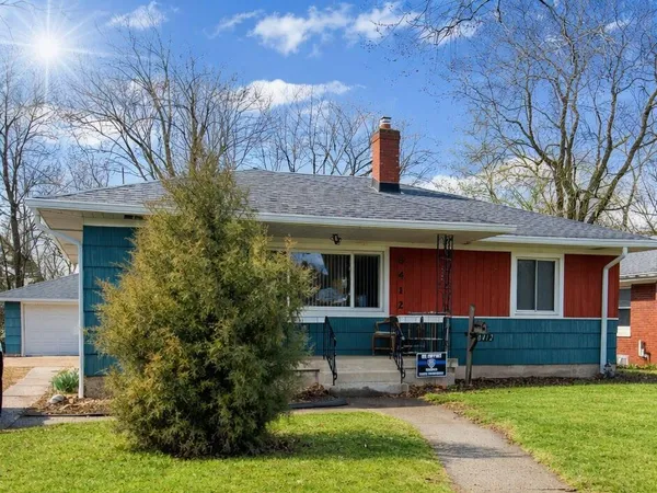a view of a house with a yard porch and sitting area