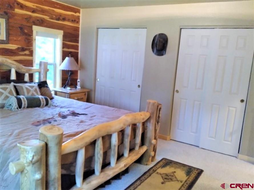 100 Crest Drive Cimarron, CO 81220 - Photo 12 of 35 a bedroom with a bed and wooden floor