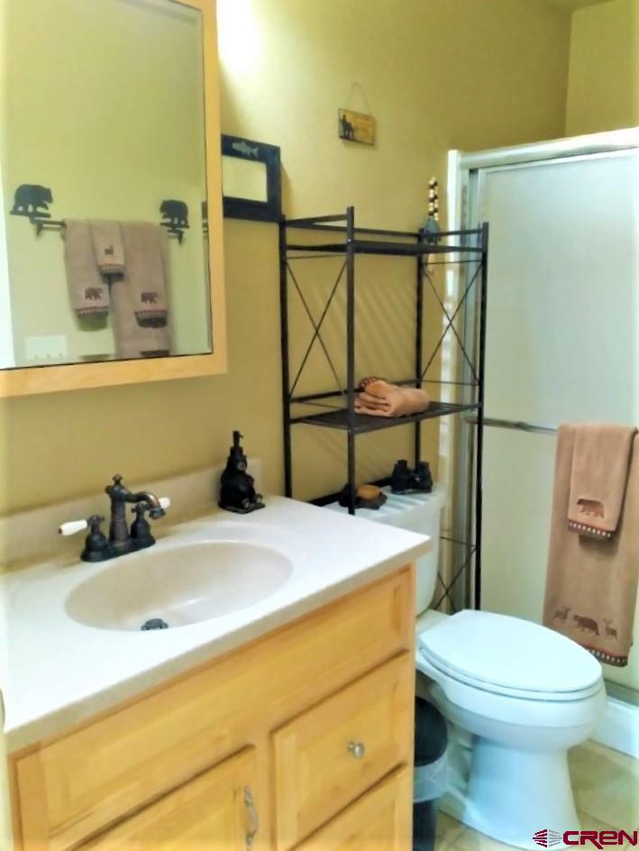 100 Crest Drive Cimarron, CO 81220 - Photo 17 of 35 a bathroom with a sink a toilet and mirror