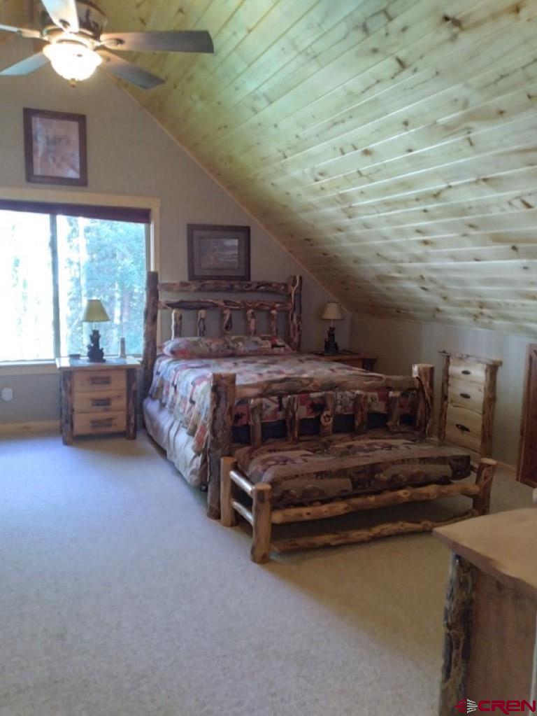 100 Crest Drive Cimarron, CO 81220 - Photo 20 of 35 a bedroom with a bed and a night stand