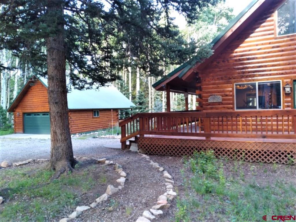 100 Crest Drive Cimarron, CO 81220 - Photo 2 of 35 a view of a house with wooden deck and a yard