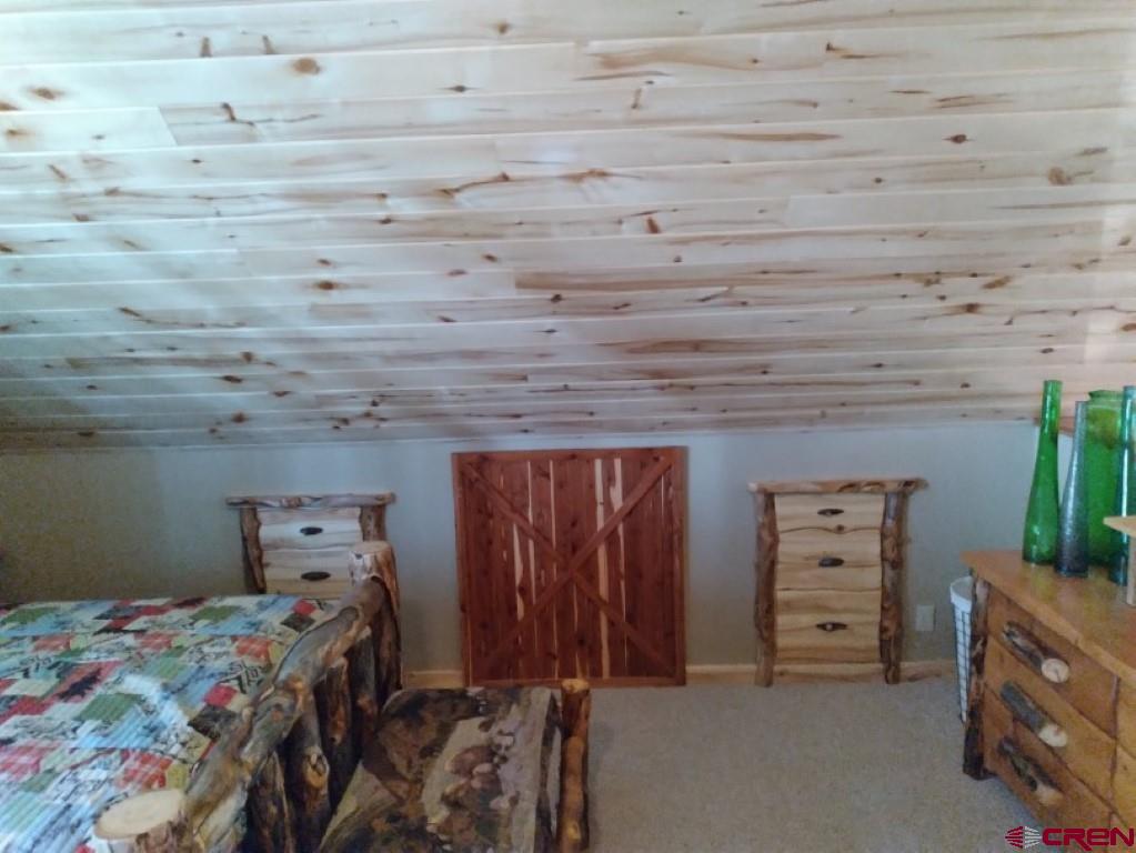100 Crest Drive Cimarron, CO 81220 - Photo 21 of 35 a bed room with a bed and furniture