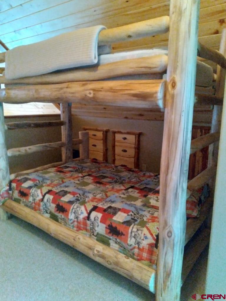 100 Crest Drive Cimarron, CO 81220 - Photo 22 of 35 a bedroom with bed and window