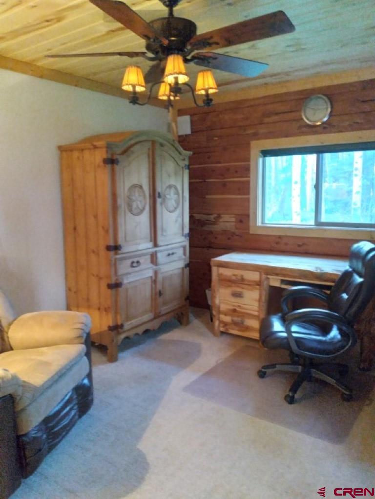 100 Crest Drive Cimarron, CO 81220 - Photo 26 of 35 a living room with a furniture and a fireplace
