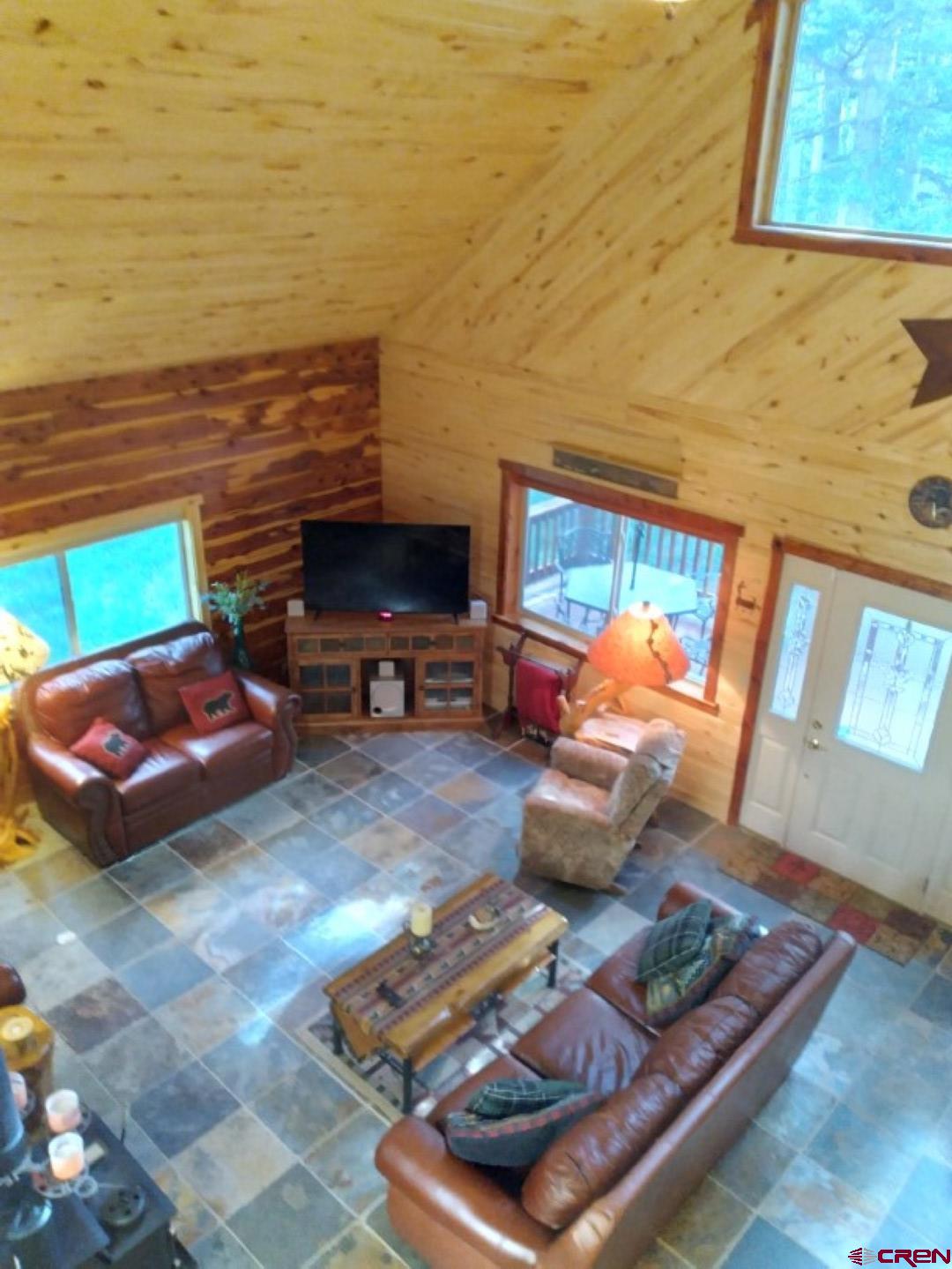 100 Crest Drive Cimarron, CO 81220 - Photo 4 of 35 a living room with furniture and a flat screen tv