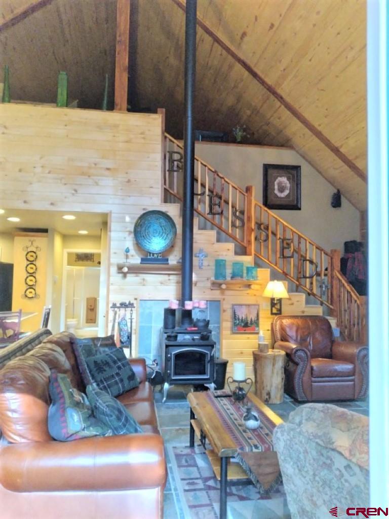 100 Crest Drive Cimarron, CO 81220 - Photo 5 of 35 a living room with furniture and a fireplace