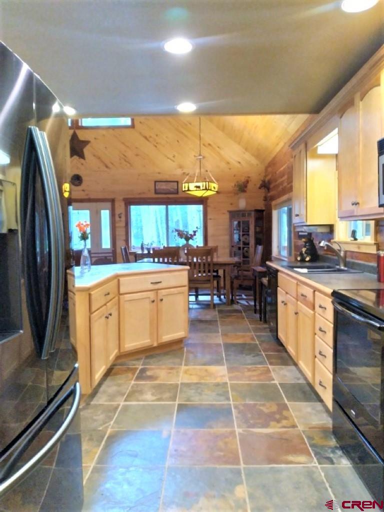 100 Crest Drive Cimarron, CO 81220 - Photo 7 of 35 a kitchen with stainless steel appliances granite countertop a stove a sink and a refrigerator