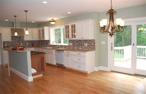 26 Patterson Road Lexington, MA 02421 - Photo 8 of 22 a kitchen with stainless steel appliances granite countertop a stove a sink dishwasher a refrigerator and white cabinets with wooden floor