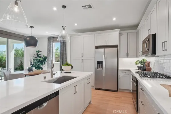 a kitchen with refrigerator a sink and cabinets