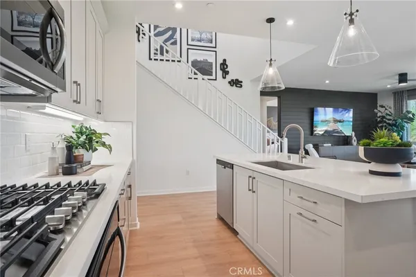 a kitchen with a sink and stove