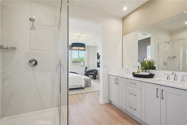 a bathroom with a sink a faucet a potted plant and a mirror
