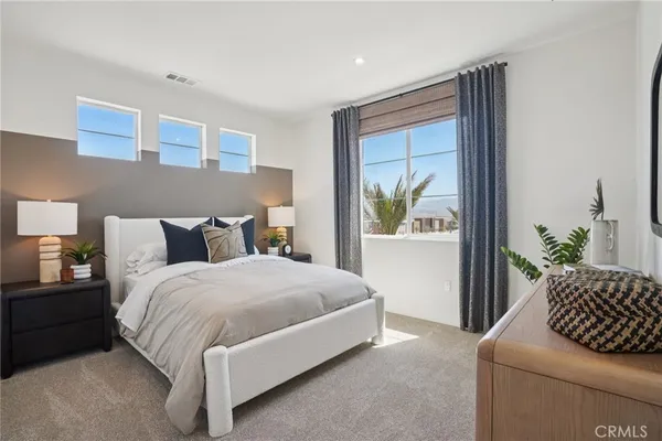 a bedroom with a bed and a mirror