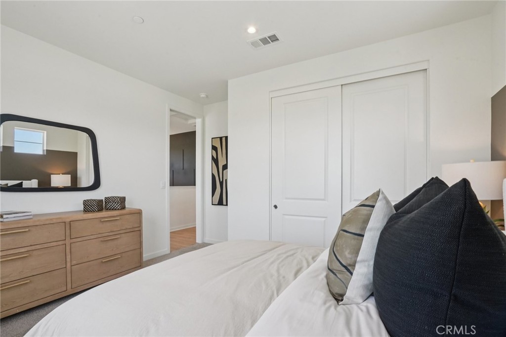 73550 Raphael Drive Palm Desert, CA 92211 - Photo 25 of 41 a bedroom with a bed and a mirror