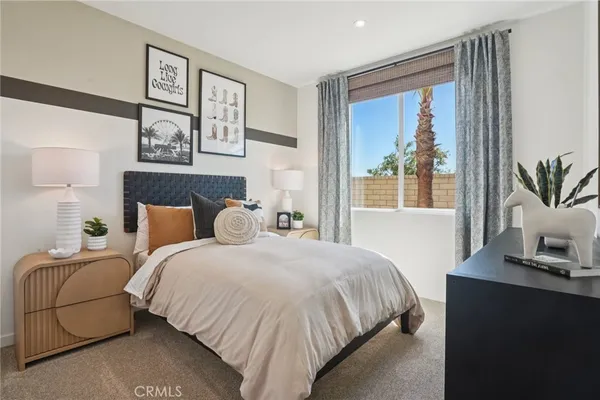 a bedroom with a bed and a mirror