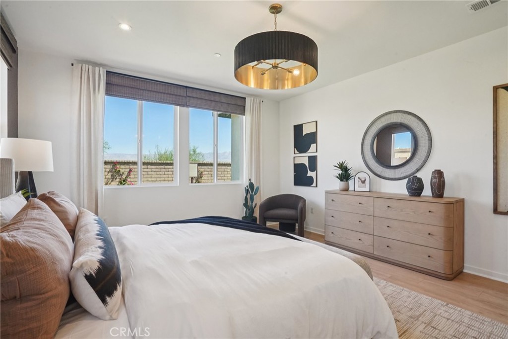 73550 Raphael Drive Palm Desert, CA 92211 - Photo 39 of 41 a bedroom with a bed and a chandelier