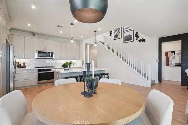 a kitchen with sink and refrigerator