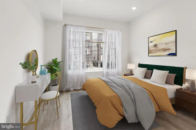 a bedroom with a bed and a potted plant