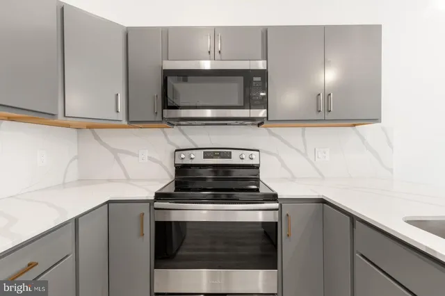 a stove top oven sitting inside of a kitchen