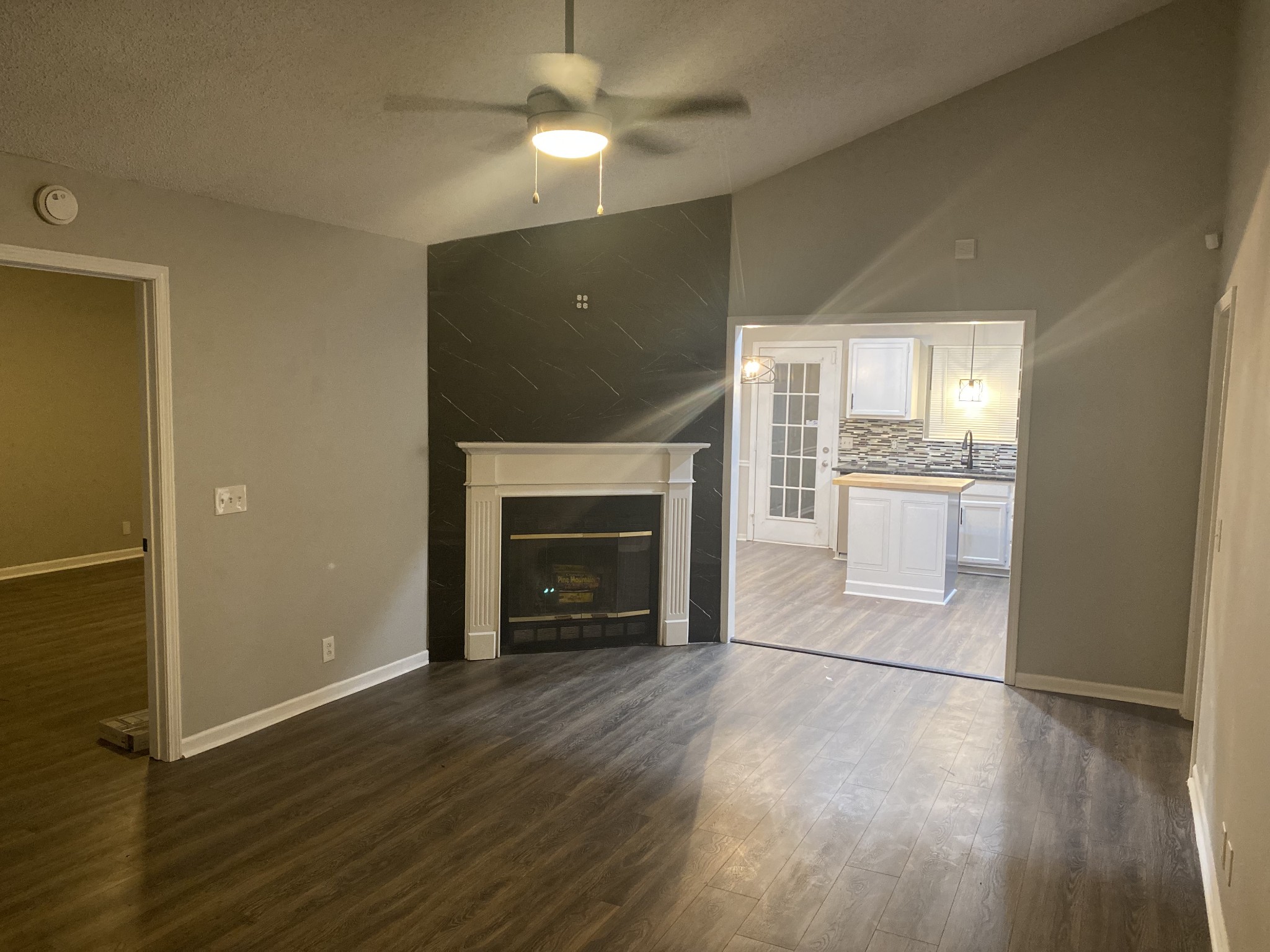 3508 Country Way Road Antioch, TN 37013 - Photo 2 of 11 an empty room with wooden floor a fireplace and windows