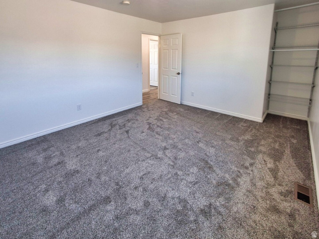 1510 South Lawrence Road Huntington, UT 84528 - Photo 11 of 16 Neutral tone walls with gray carpeting, white baseboards, and a built-in closet system