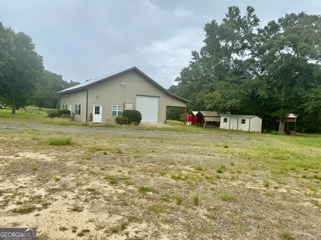 a house with green field in front of it
