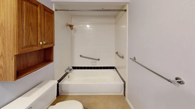 a bathroom with a tub and shower