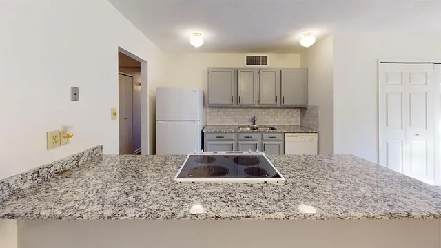a kitchen with kitchen island sink refrigerator and stove