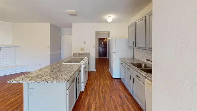 a kitchen with stainless steel appliances granite countertop a stove and a refrigerator
