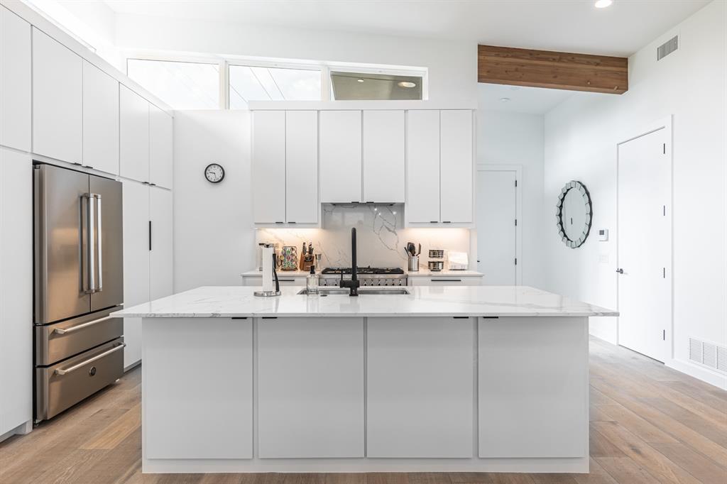 4202 Bonham Street Dallas, TX 75229 - Photo 10 of 32 Kitchen with high quality fridge, white cabinetry, recessed lighting, light wood-style floors, and beamed ceiling