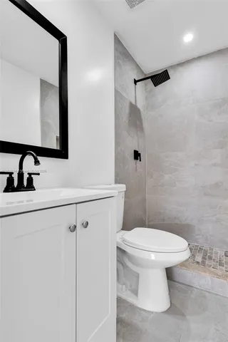 a bathroom with a toilet sink and shower