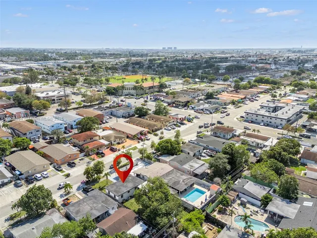 an aerial view of residential houses with outdoor space