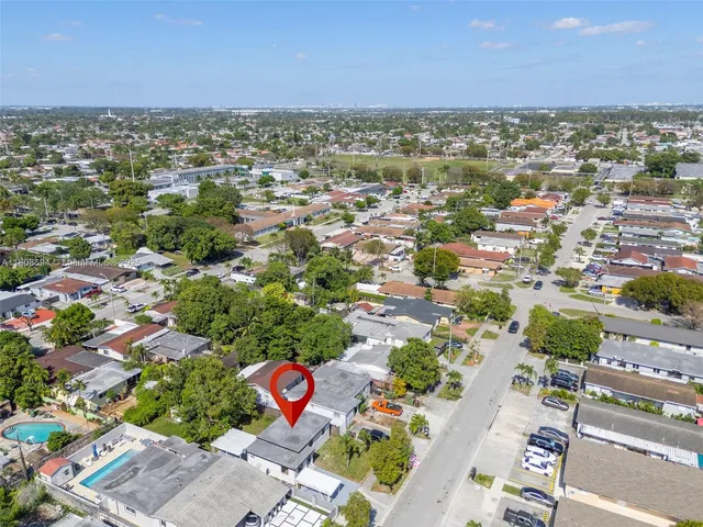an aerial view of residential houses with outdoor space
